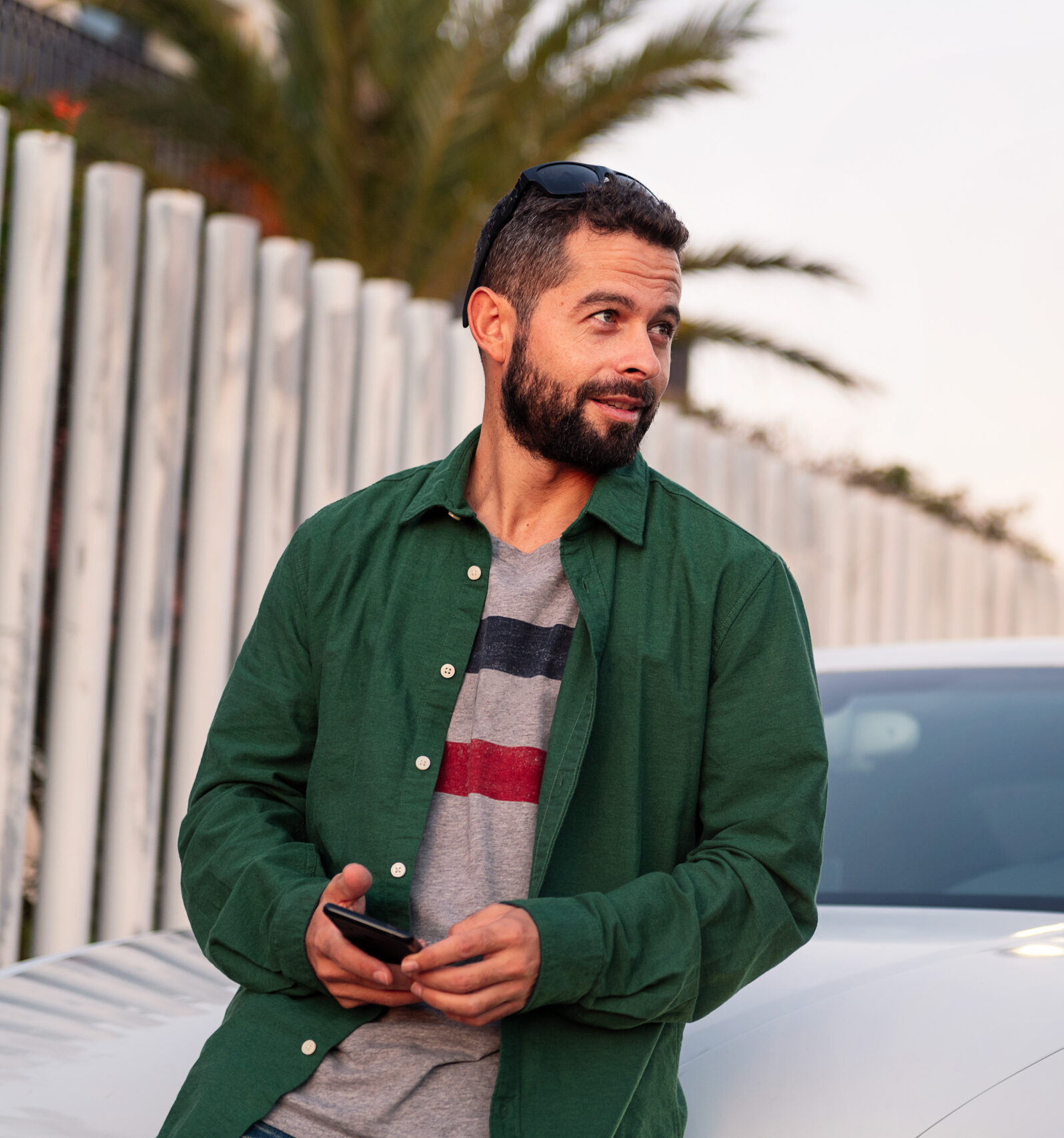 man on the hood of his car with phone in hand 2023 11 27 04 48 58 utc scaled e1726700608367